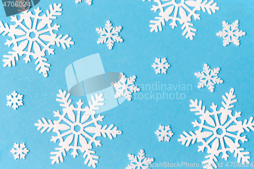 Image of white snowflake decorations on blue background