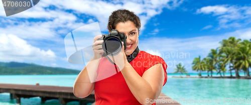 Image of happy woman photographer with camera on vacation