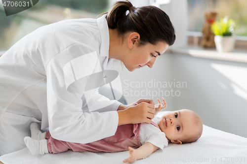 Image of female pediatrician doctor with baby at clinic