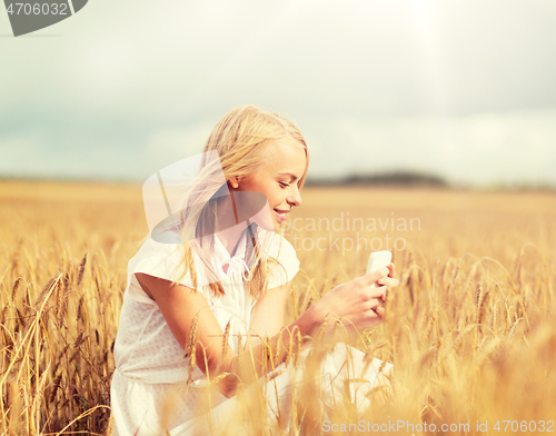 Image of happy woman with smartphone and earphones