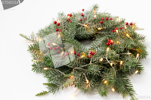 Image of christmas fir wreath with berries and lights