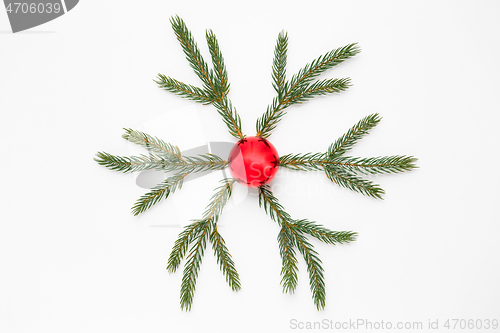 Image of christmas ornament of fir branches and red ball