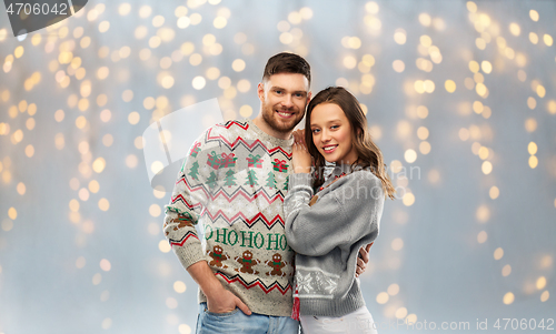 Image of happy couple at christmas ugly sweater party