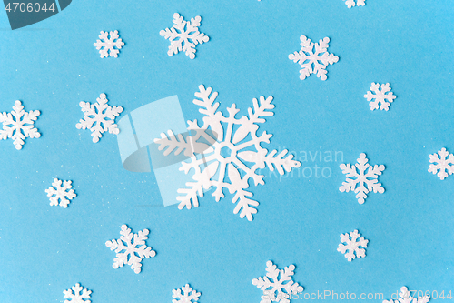 Image of white snowflake decorations on blue background
