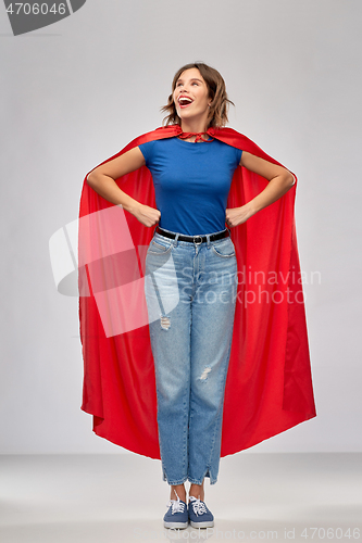 Image of happy woman in red superhero cape