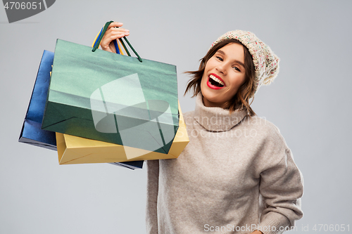 Image of young woman in winter hat with shopping bags