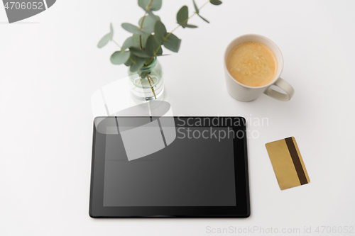 Image of tablet pc computer, credit card and cup of coffee