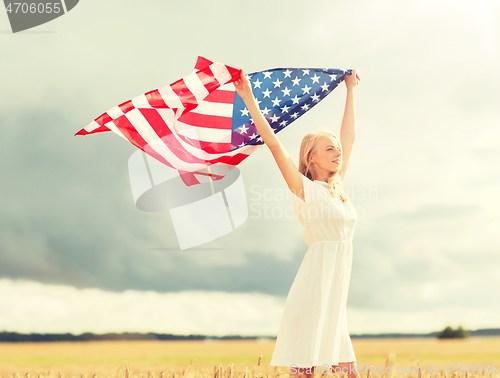 Image of happy woman with american flag on cereal field