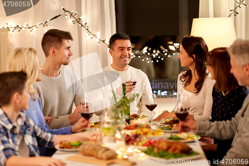 Image of happy family having dinner party at home