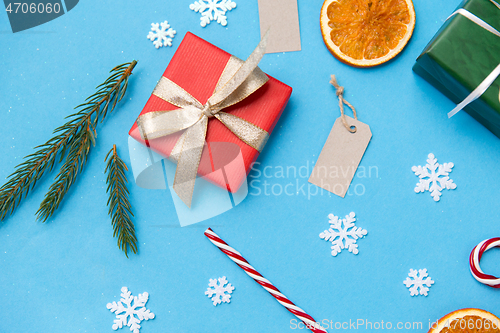 Image of christmas gifts, branches, tags and decorations