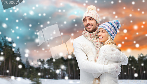 Image of smiling couple in winter clothes hugging