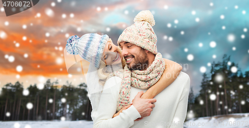 Image of smiling couple in winter clothes hugging