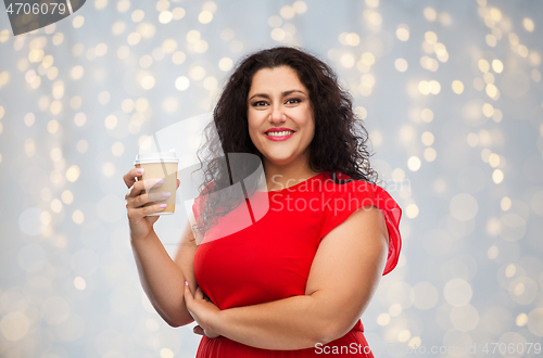 Image of woman in red dress holding takeaway coffee cup