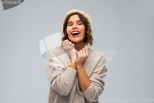 Image of young woman in knitted winter hat and sweater