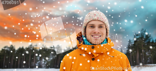 Image of happy young man in winter clothes outdoors