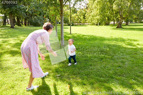 Image of happy mother and son having fun at summer park