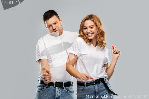 Image of portrait of happy couple in white t-shirts dancing