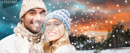 Image of smiling couple in winter clothes hugging