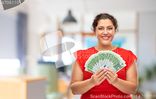 Image of happy woman holding hundreds of money banknotes