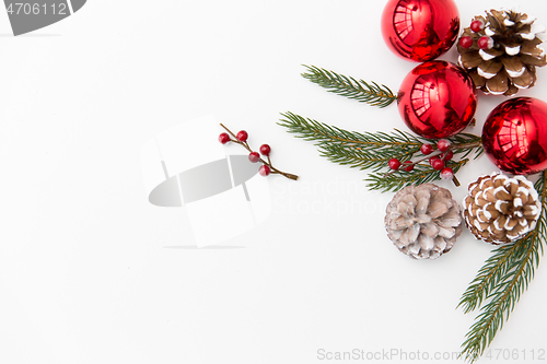 Image of christmas balls and fir branches with pine cones