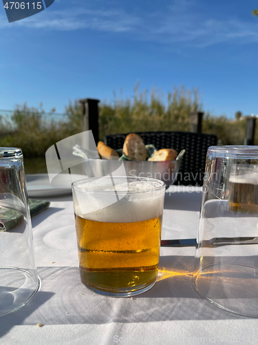 Image of Glass of beer on the cafe table