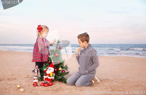 Image of Getting ready for Christmas holidays. Family party on the beach