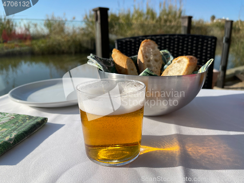 Image of Cafe table with a glass of beer and bread