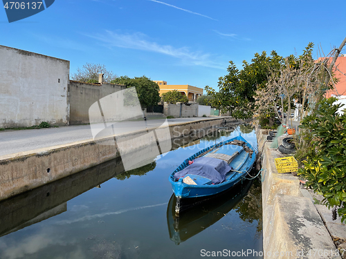 Image of El Palmar scene with boat moored in the channel, Spain