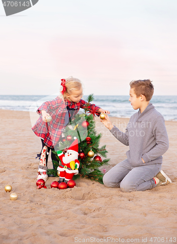 Image of Siblings preparing for the Christmas party on the beach