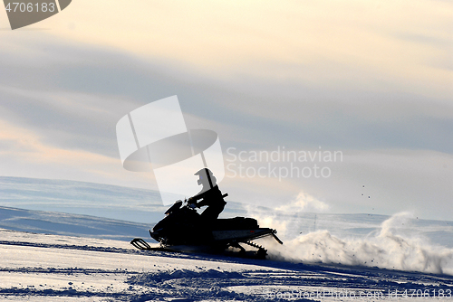 Image of Silhouette on snow-scooter