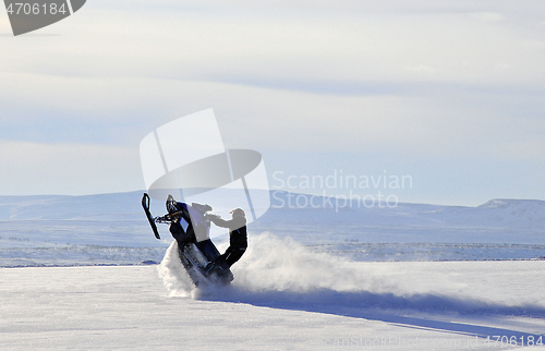 Image of Making tricks on his snow scooter