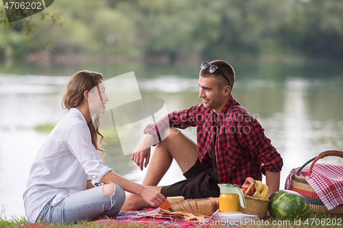 Image of Couple in love enjoying picnic time