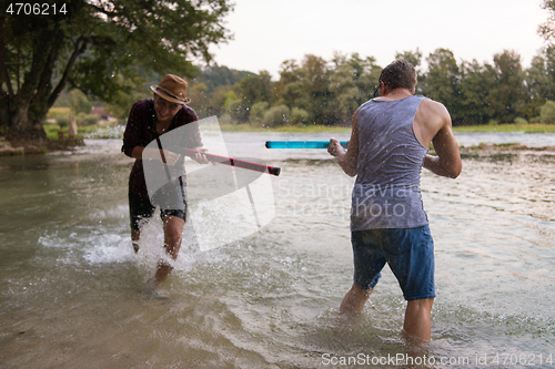 Image of young men having fun with water guns