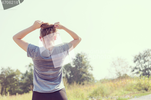 Image of woman jogging along a country road