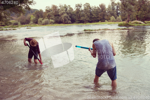 Image of young men having fun with water guns