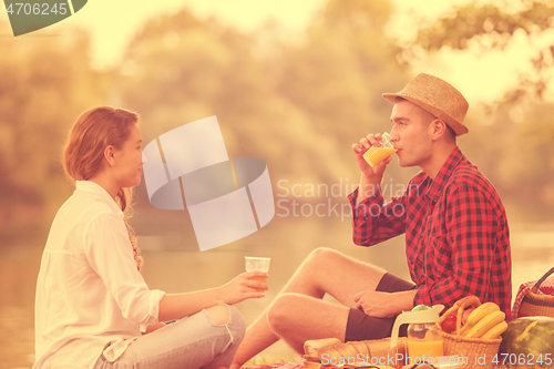 Image of Couple in love enjoying picnic time