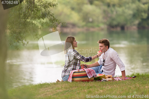 Image of Couple in love enjoying picnic time