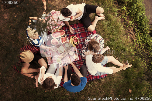 Image of top view of group friends enjoying picnic time