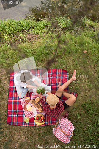 Image of top view of couple enjoying picnic time