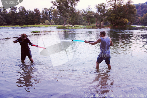 Image of young men having fun with water guns