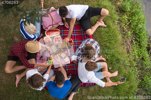 Image of top view of group friends enjoying picnic time