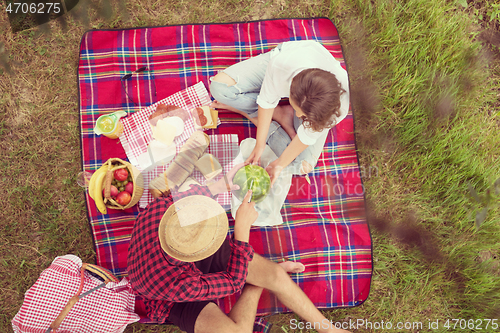 Image of top view of couple enjoying picnic time