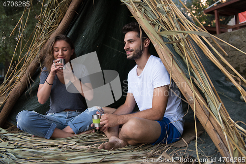 Image of couple spending time together in straw tent