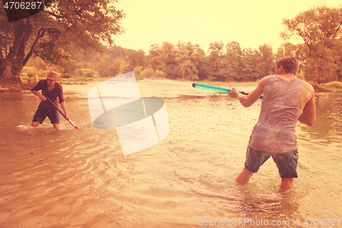 Image of young men having fun with water guns