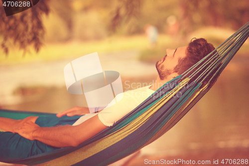 Image of man resting on hammock