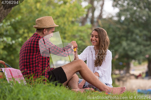 Image of Couple in love enjoying picnic time