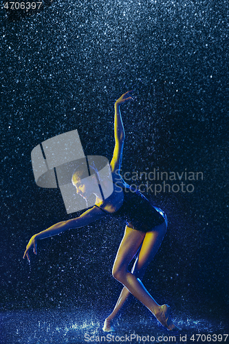Image of Two young female ballet dancers under water drops