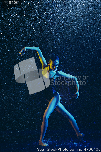 Image of Two young female ballet dancers under water drops