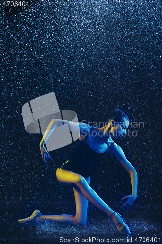 Image of Two young female ballet dancers under water drops