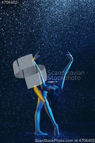 Image of Two young female ballet dancers under water drops
